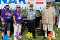 group posing in front of NARFE banner