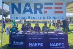 group sitting behind tables