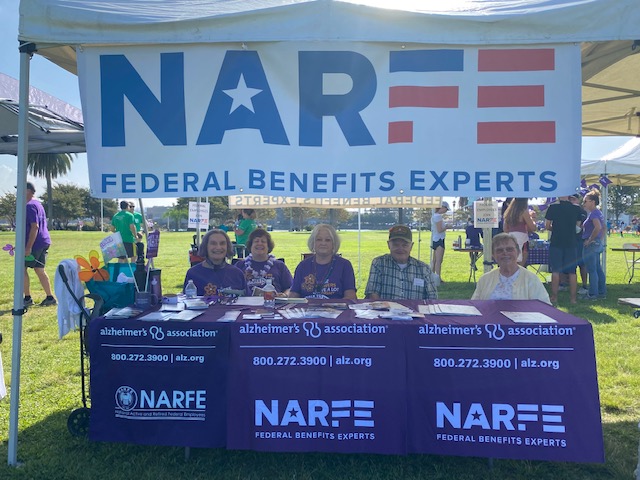 group sitting behind tables