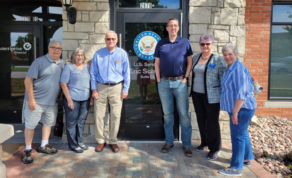 Five members of Chapter 0011 with a member of Senator Schmitt's staff