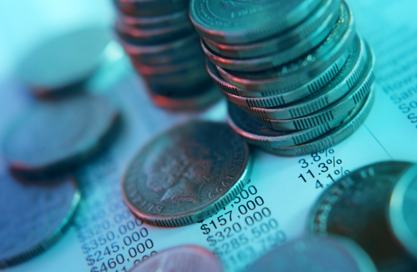 stacked quarters on top of spreadsheet