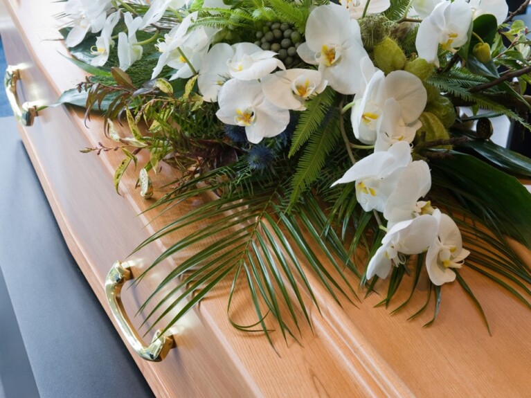 White flowers on top of a casket