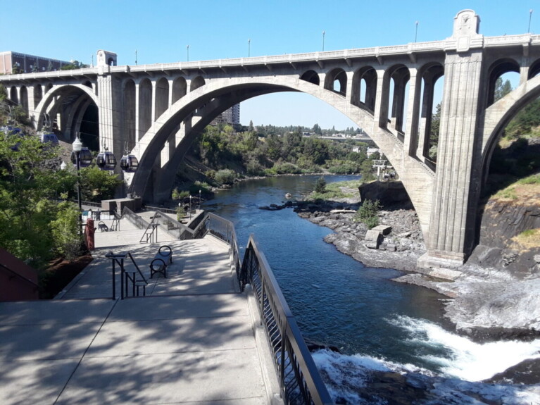 River flowing beneath arched bridge