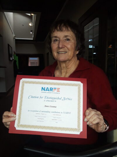 Portrait of lady holding Citation of Distinguished Service