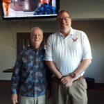 Two men standing side-by-side.