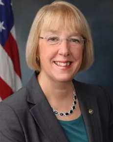 Portrait of blond lady with eyeglasses.