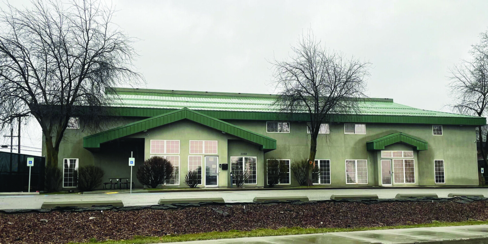 Street view of green office building.