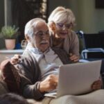 Senior couple looking at laptop computer.