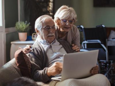 Senior couple looking at laptop computer.