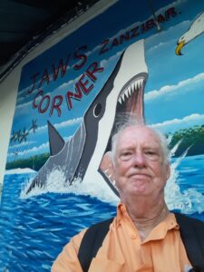 Man's head in the jaws of painted shark.