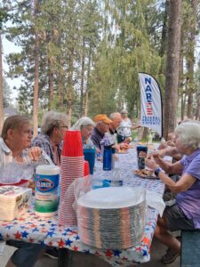 People eating around a picnic table.