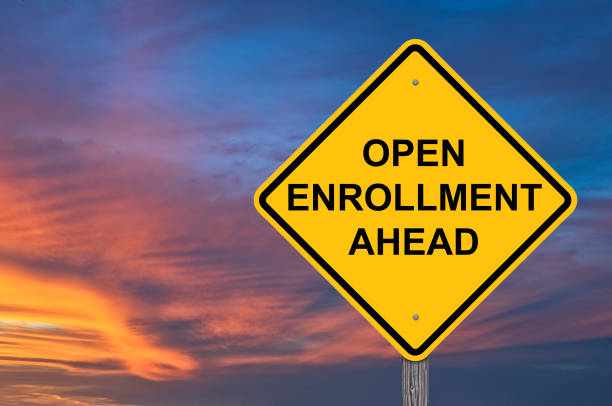 Yellow traffic sign that reads open enrollment ahead.