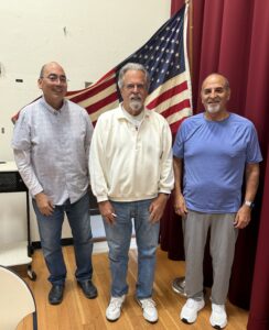 Chapter 0046 officers standing with US flag