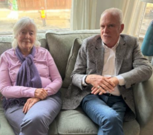 woman and man sitting on sofa