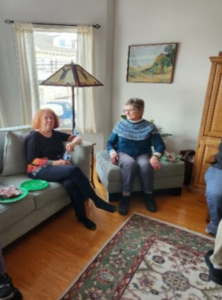 two women sitting on sofa