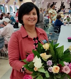 smiling woman holding flowers