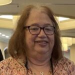 woman with brown hair and glasses