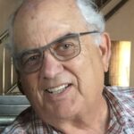 man with glasses in plaid shirt