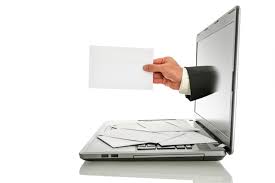 hand holding letter reaching through computer screen