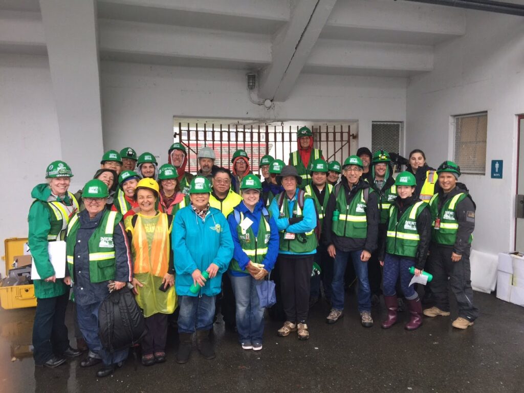 group of people with green vests and hard hats