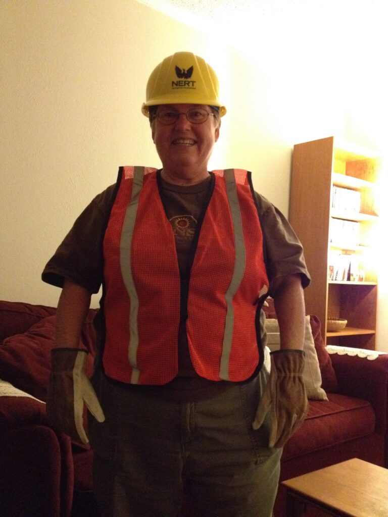 woman with orange vest and yellow hard hat
