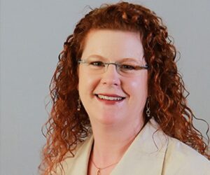 woman with red hair and glasses