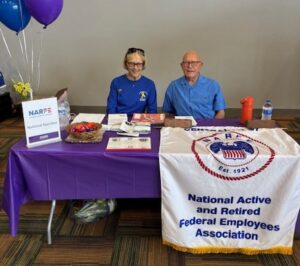 Picture of Mary Jo Billiter Chapter 2nd VP & co-caption of Alzheimer’s Walk and Tony Burgett, Chapter Program/Hospitality chair seated at the NARFE table.
