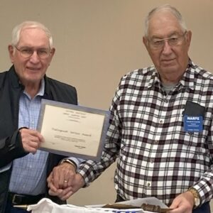 Picture of member being presented with award from outgoing Chapter President