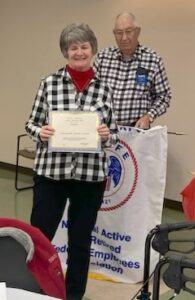 Picture of member being presented with award by out-going Chapter President