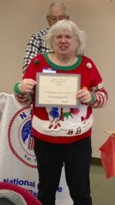 Picture of member being presented with award by out-going Chapter President