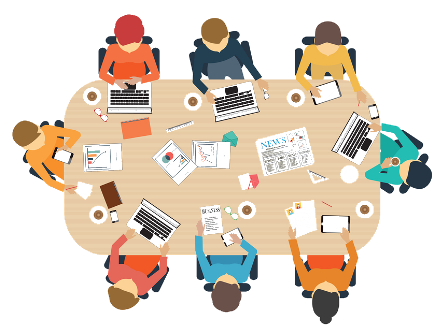 a work table with members sitting around with papers and devices working on a project