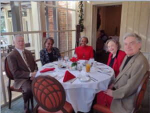 Picture of People sitting around the table. 2023 Holiday Luncheon at Mere Bulles Restaurant