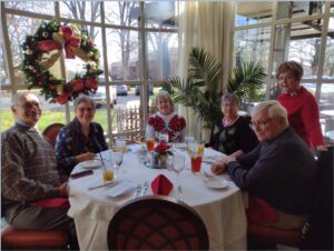 Picture of People sitting around the table. 2023 Holiday Luncheon at Mere Bulles Restaurant