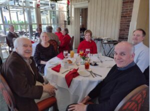 Picture of People sitting around the table. 2023 Holiday Luncheon at Mere Bulles Restaurant