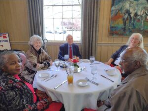 Picture of People sitting around the table. 2023 Holiday Luncheon at Mere Bulles Restaurant
