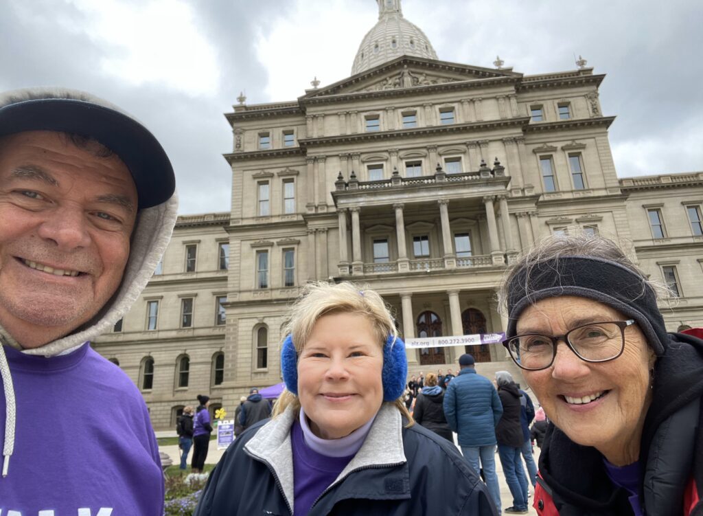 Three team members in front of the Michigan State Capitol to begin the Walked to End Alzheimer's Event