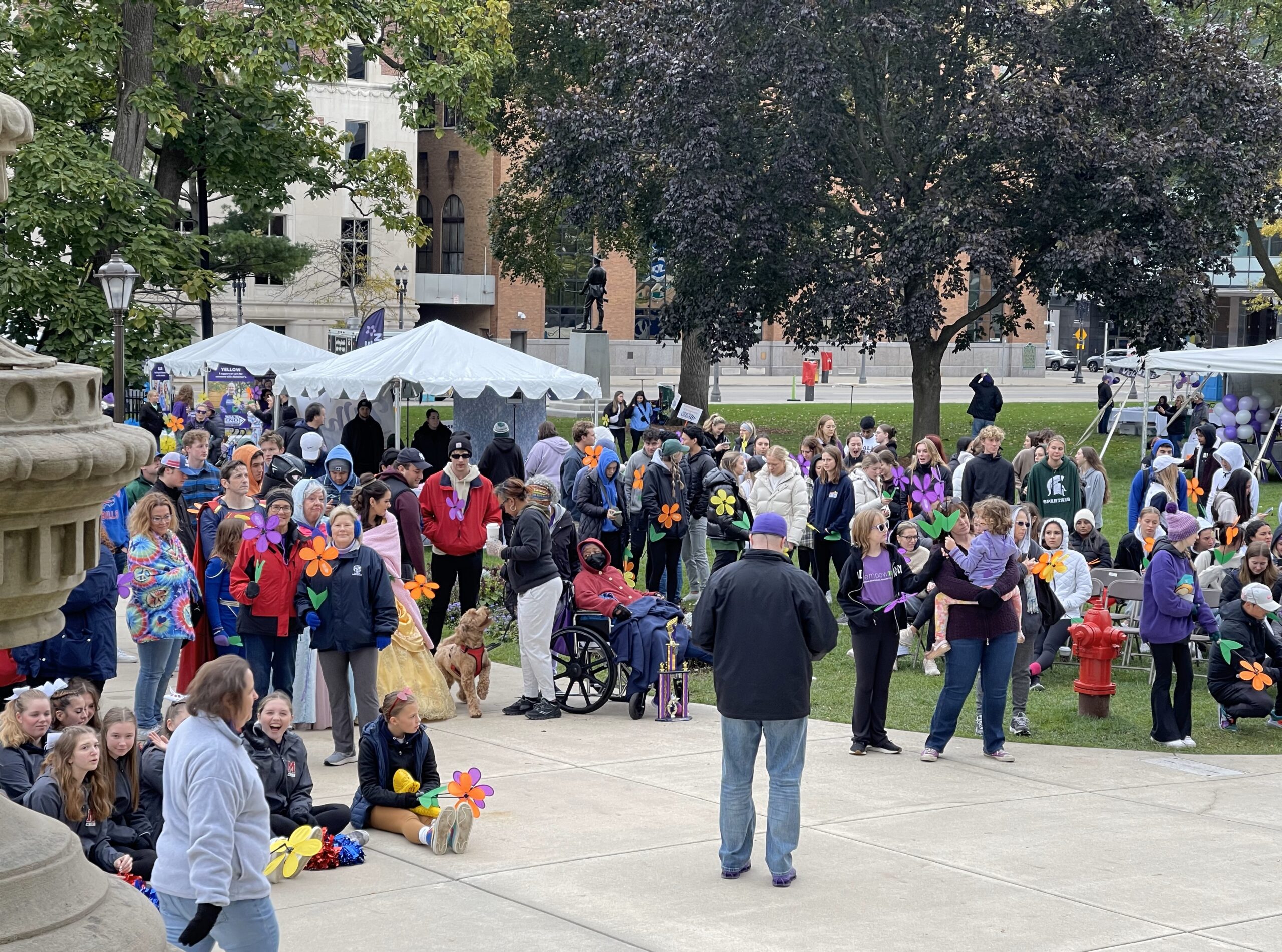 Photo of crowd at walk, our team is a left holding flowers