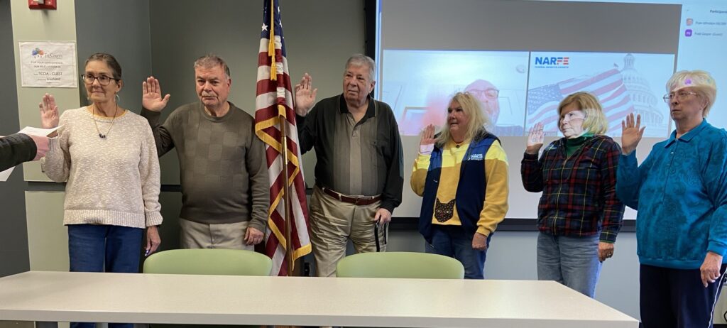 Photo of installation of Lansing Chapter Officers standing in the front of the meeting room.