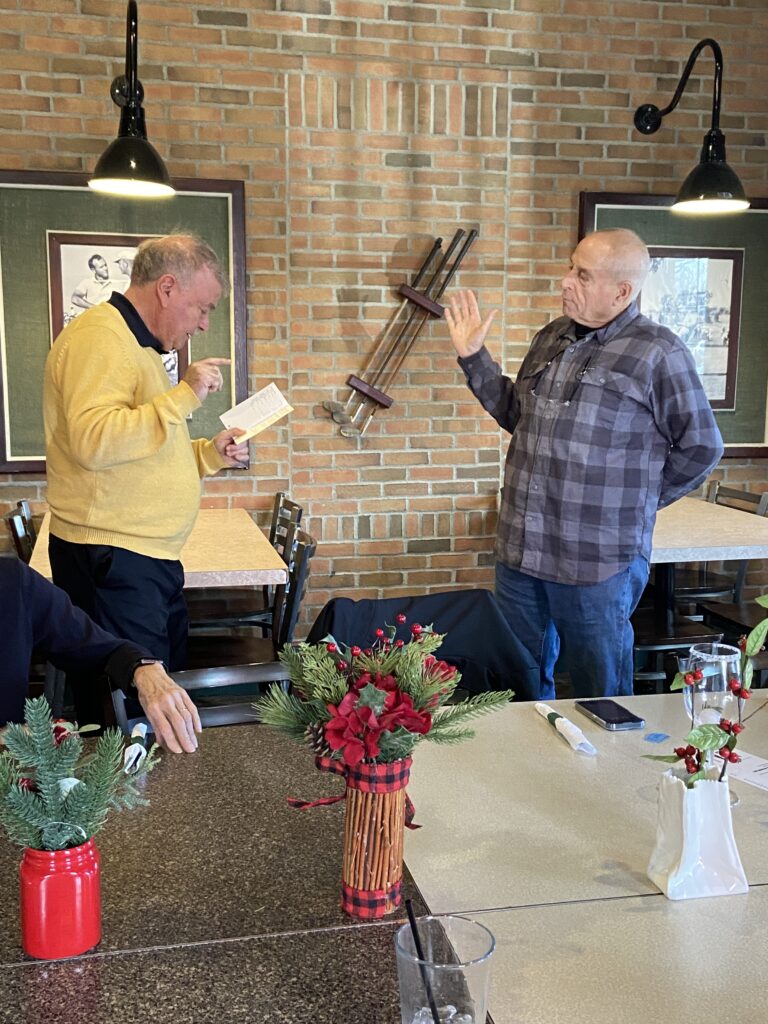 Picture of Michigan Federation President give the oath of office to the Lansing Chapter Nomination Chair at the Holiday Party.