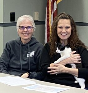 Penny Myers, Dir. Community Relations, Capital Area Humane Society at right holding special guest and Sue Karr, Volunteer at left.