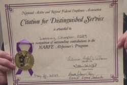 Copy of Award Lansing Chapter 289 from Alzheimer Program being held up for picture to be taken