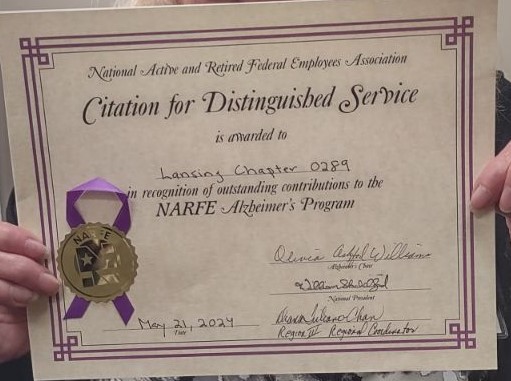 Copy of Award Lansing Chapter 289 from Alzheimer Program being held up for picture to be taken