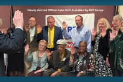 Group of officers with hands up being sworn in to office
