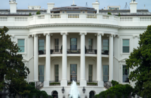 front view of The White House, Washington DC (two story building with half-circle front porch bordered by six columns reaching to roof)
