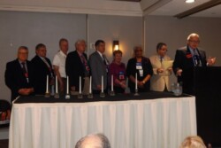 Members lighting candles during Memorial Service