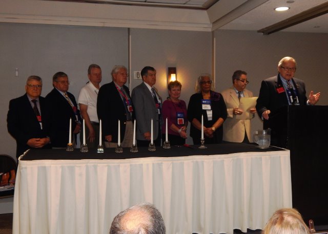 Members lighting candles during Memorial Service