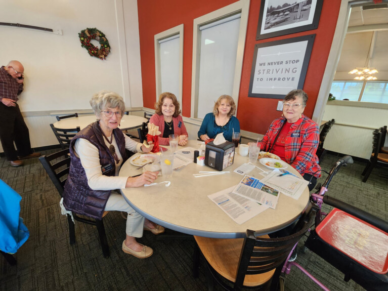 Four women enjoying holiday party