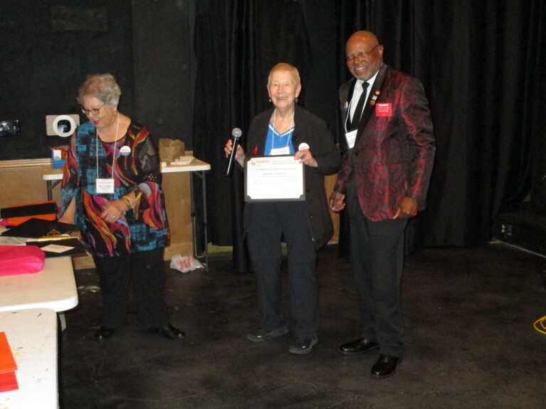 Dorothy Creswell receives an award from NARFE Texas Federation officers Steven Johnson and Dora Benavides.