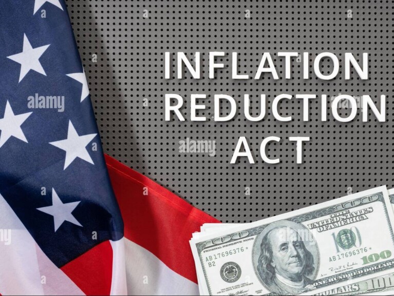 American flag, $100 bills and text Inflation Reduction Act