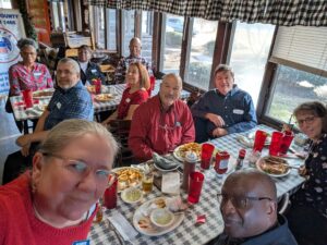 Multiple people gathered, enjoying fellowship at the annual holiday party